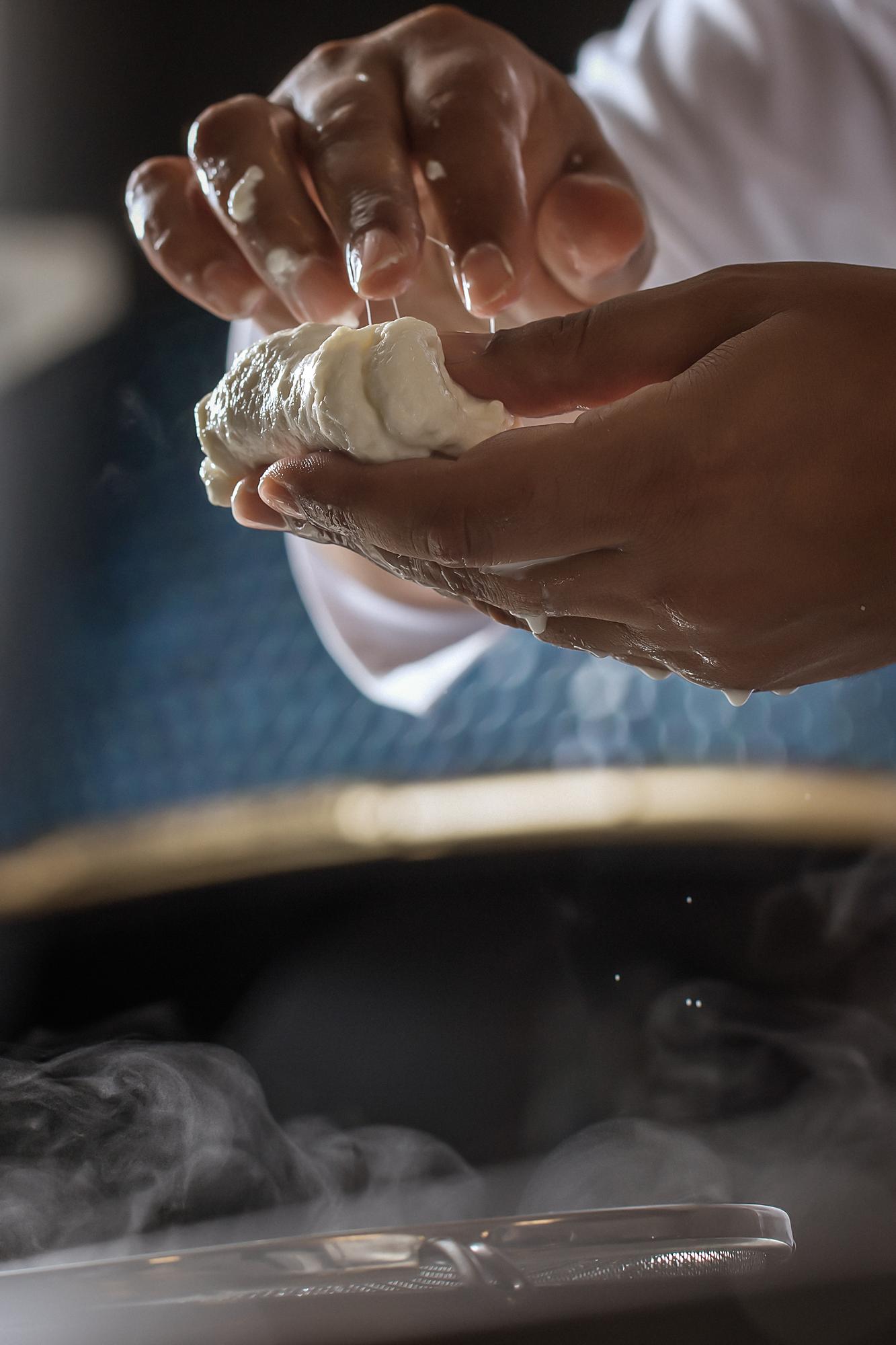 Close-up of hands kneading dough