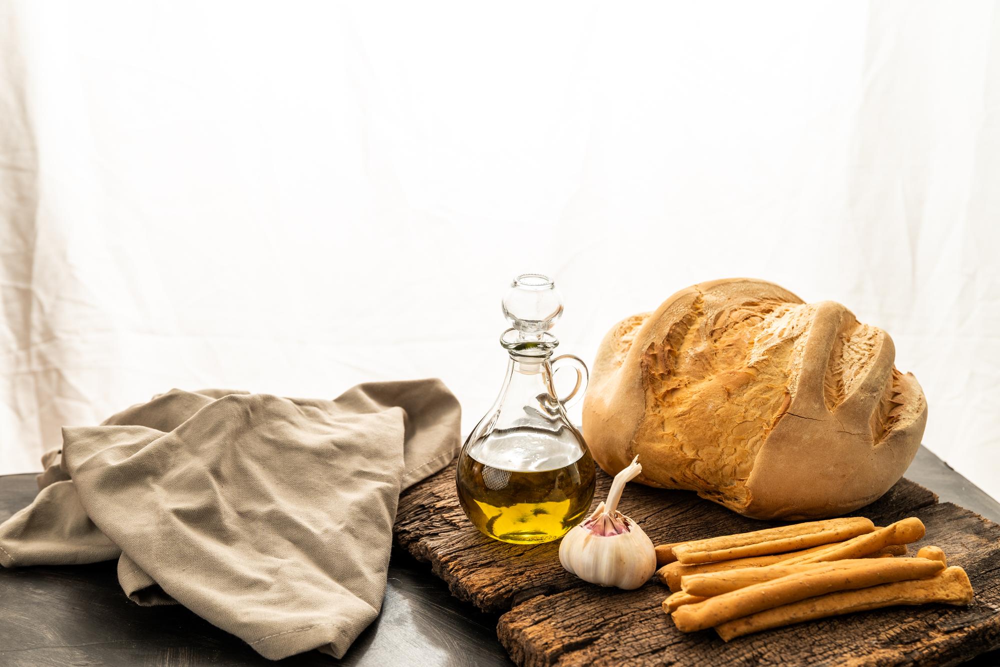 Rustic table setting with bread and olive oil