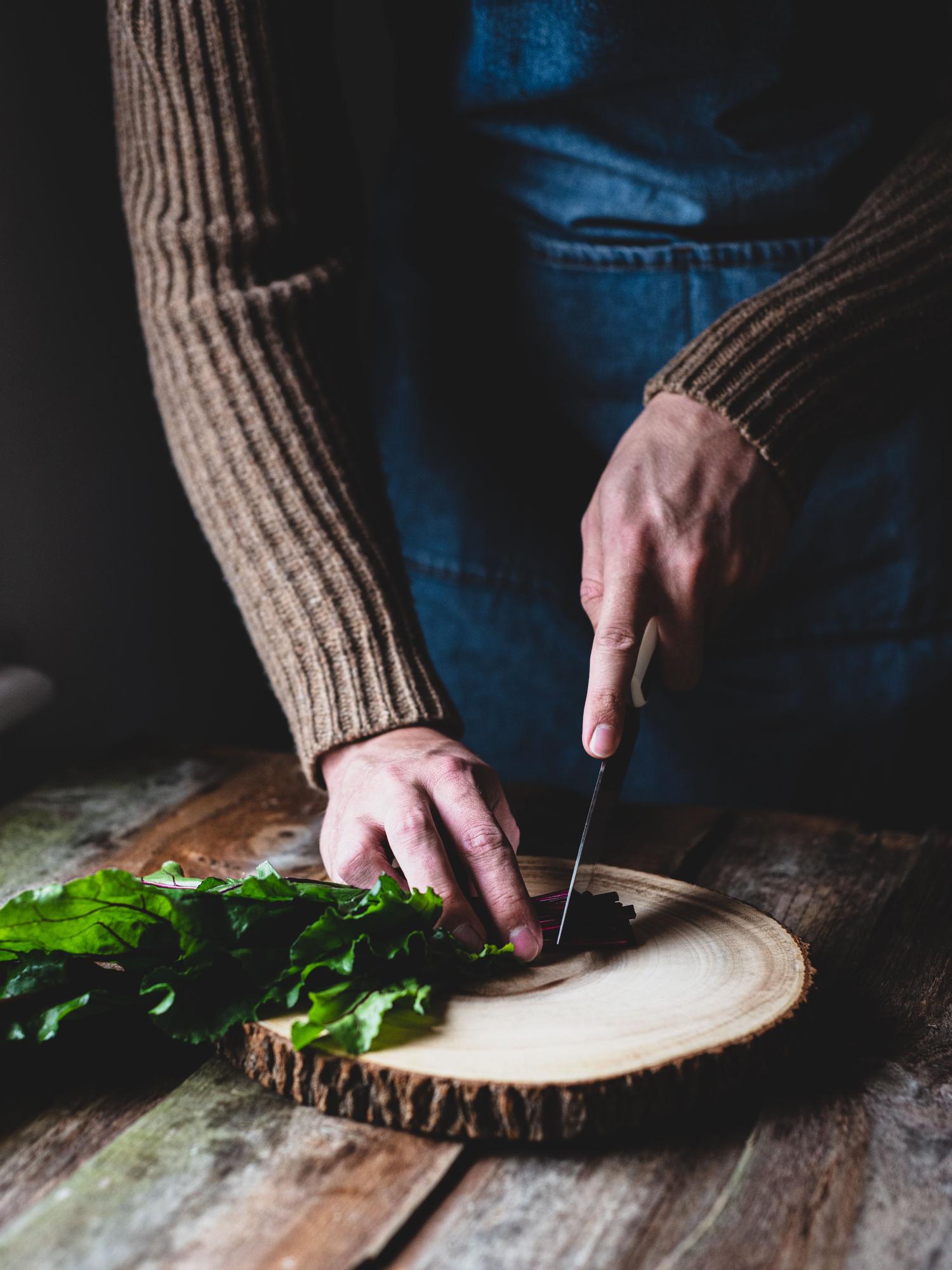 Chef preparing seasonal dish on wooden table